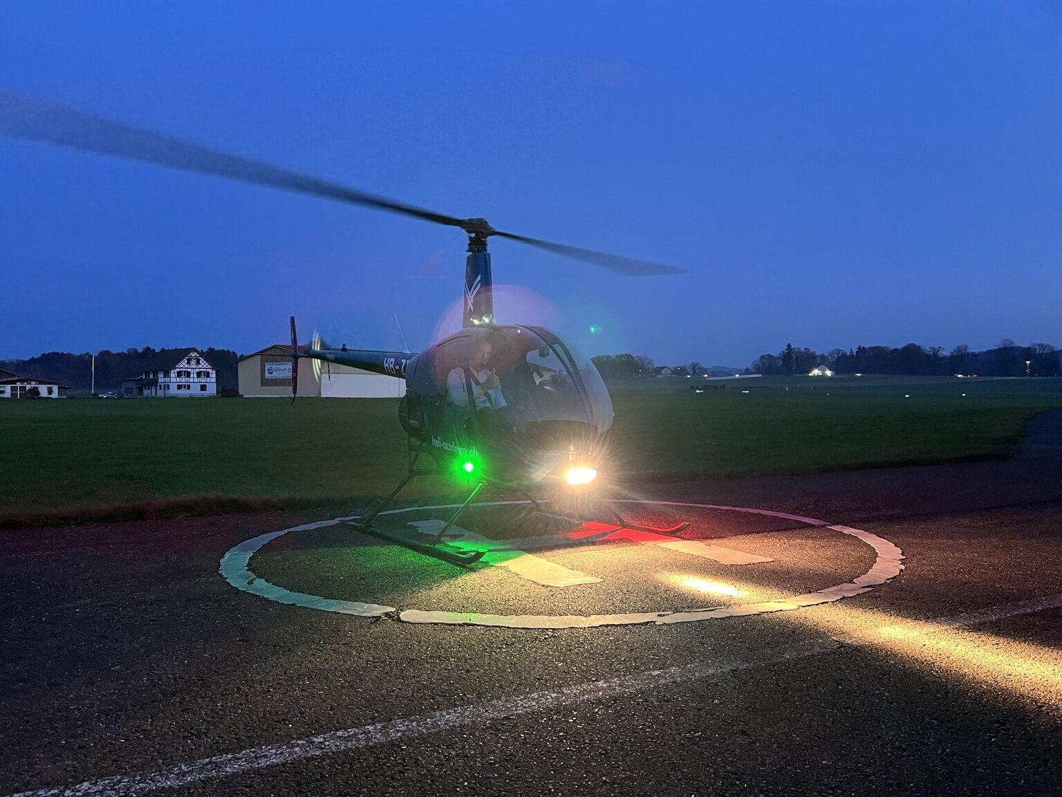 Robinson R22 mit eingeschalteten Lichtern